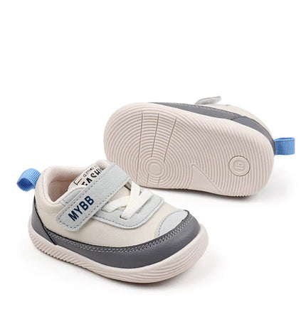White and Gray Imported baby sneakers with a soft sole, breathable mesh upper, and secure hook-and-loop strap for comfort and stability