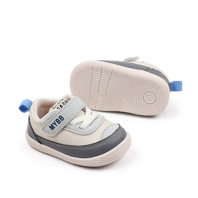 White and Gray Imported baby sneakers with a soft sole, breathable mesh upper, and secure hook-and-loop strap for comfort and stability