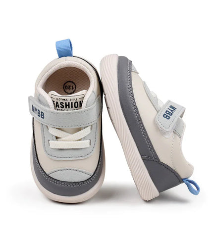 White and Gray Imported baby sneakers with a soft sole, breathable mesh upper, and secure hook-and-loop strap for comfort and stability