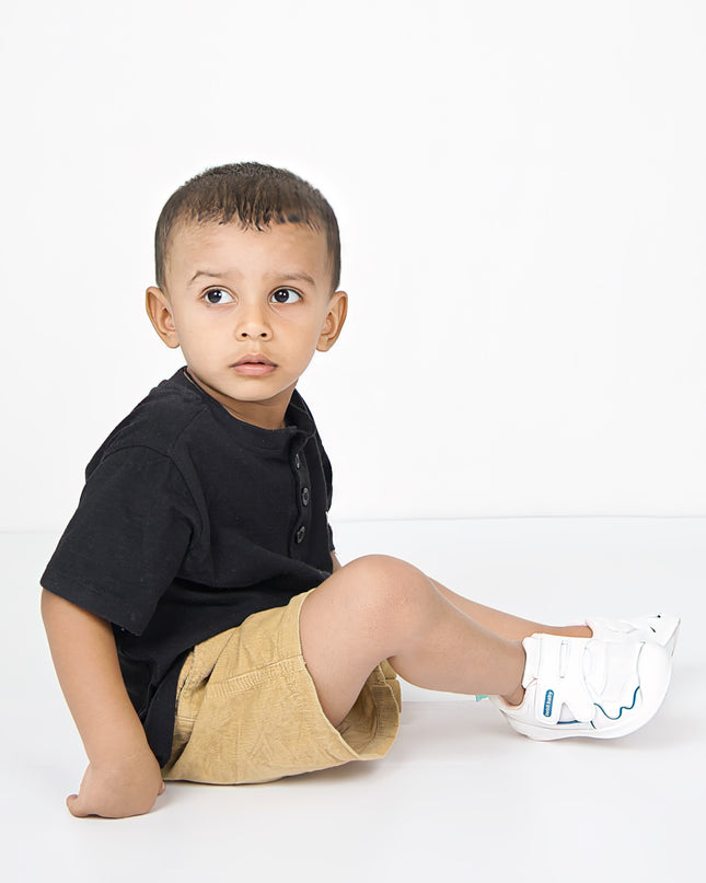 White toddler sneakers with pink lining, blue accent and Velcro straps – lightweight baby shoes