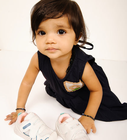 White toddler sneakers with pink lining, blue accent and Velcro straps – lightweight baby shoes