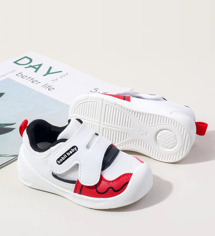 White toddler sneakers with black lining, red accent and Velcro straps – lightweight baby shoes