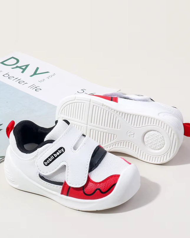 White toddler sneakers with black lining, red accent and Velcro straps – lightweight baby shoes