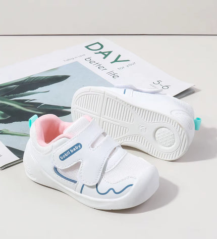 White toddler sneakers with pink lining and Velcro straps – lightweight baby shoes