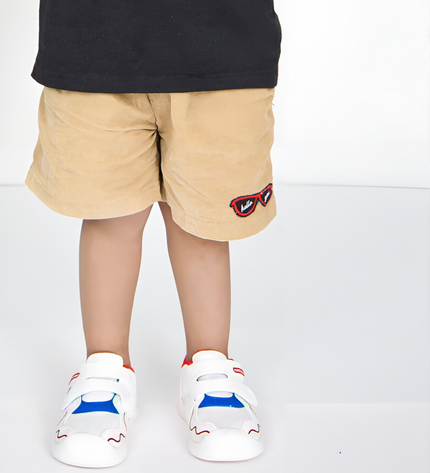 White toddler sneakers with red lining, blue accent and Velcro straps – lightweight baby shoes