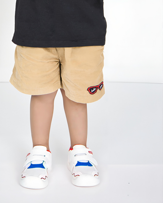 White toddler sneakers with red lining, blue accent and Velcro straps – lightweight baby shoes