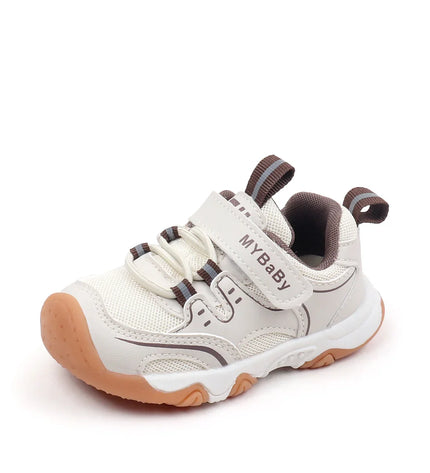 White brown combination toddler shoes with a breathable mesh upper, textured rubber sole, and secure hook-and-loop strap for comfort and stability